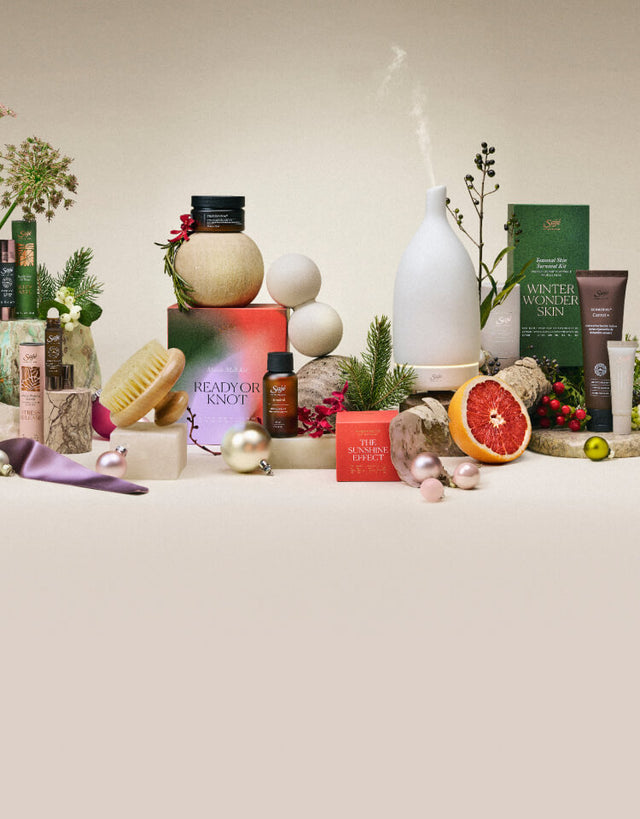 A collection of limited-edition Holiday products arranged among festive decor. 