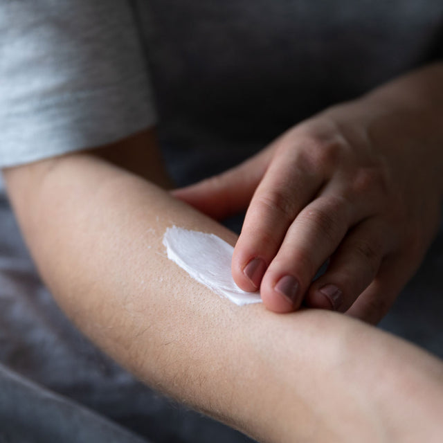 Person applying body butter to their arm